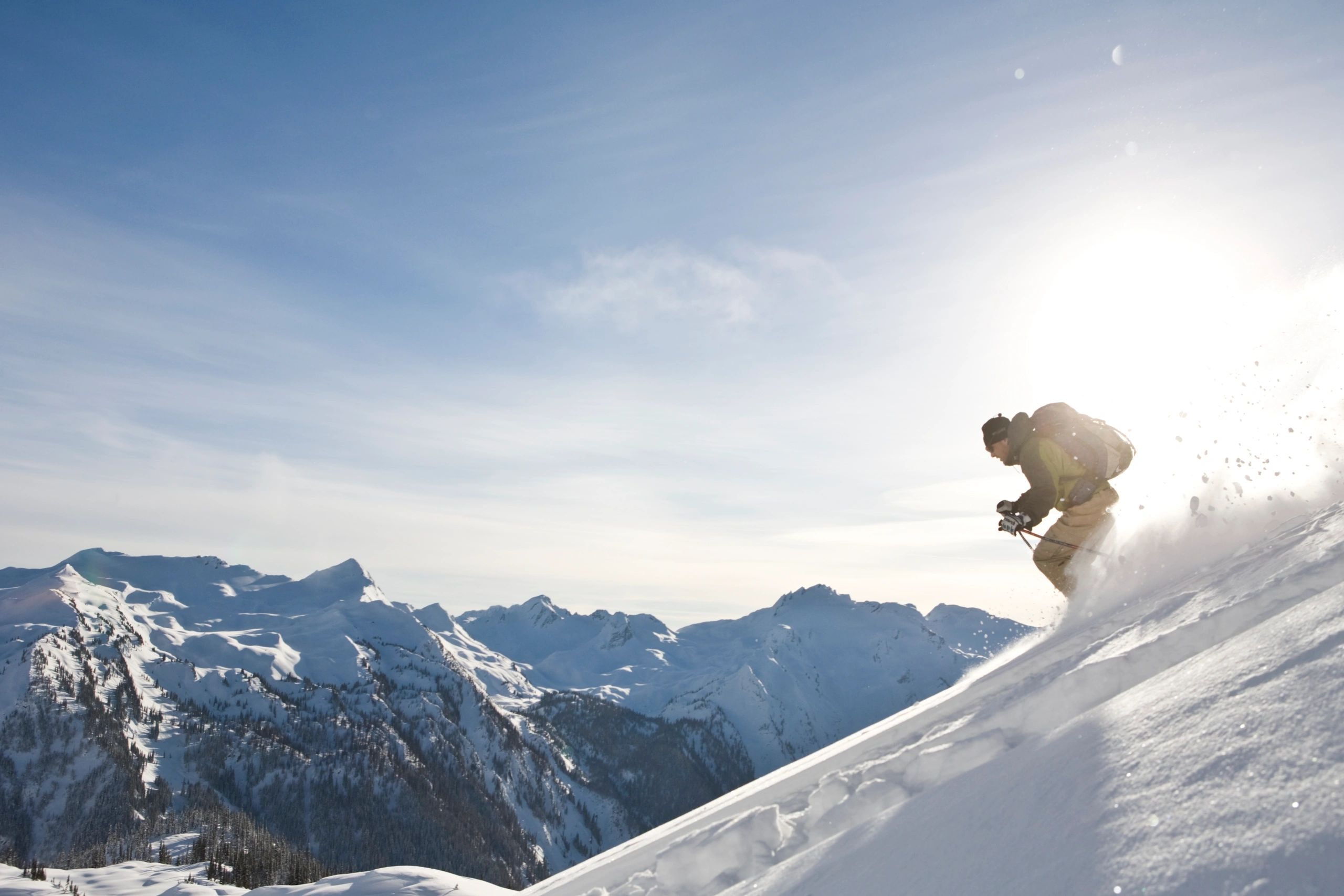 Skier mid-air on mountain slope
